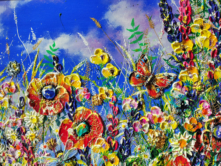 Vibrant impressionistic painting of a wildflower meadow under a bright blue sky, featuring red, yellow, pink, and white flowers with a butterfly in the center.