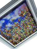 A framed colorful painting depicting a vibrant field of flowers and butterflies under a blue sky, shown at an angle with a white frame.