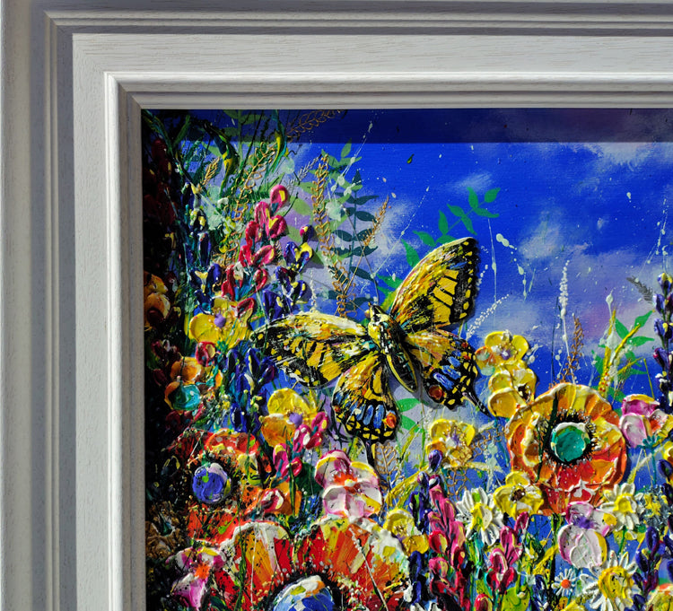 A framed colorful painting featuring a yellow and black swallow tail butterfly surrounded by vibrant wildflowers under a bright blue sky, shown with a white frame.